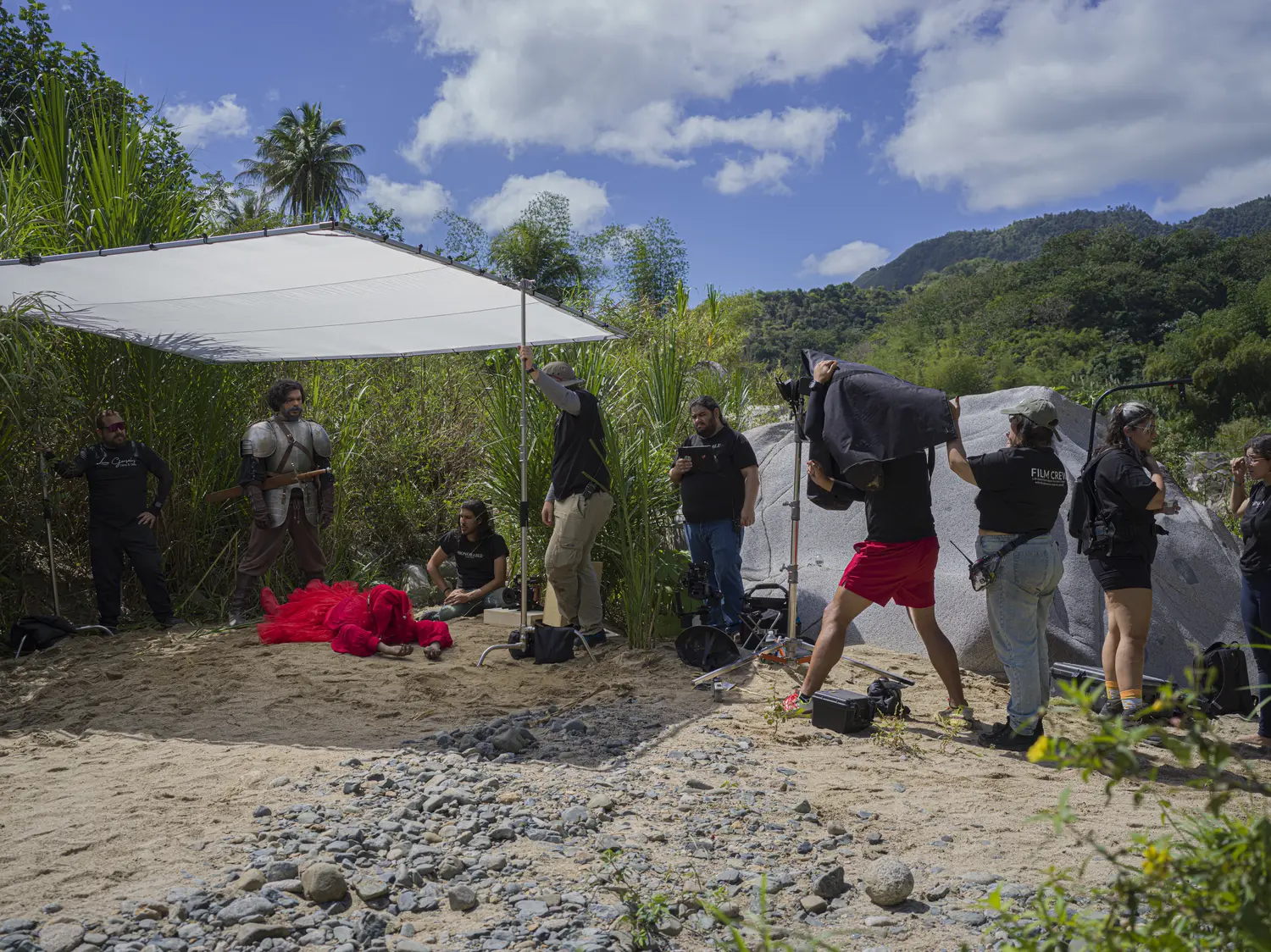 A wide riverbed under diffusion frames, mountains behind