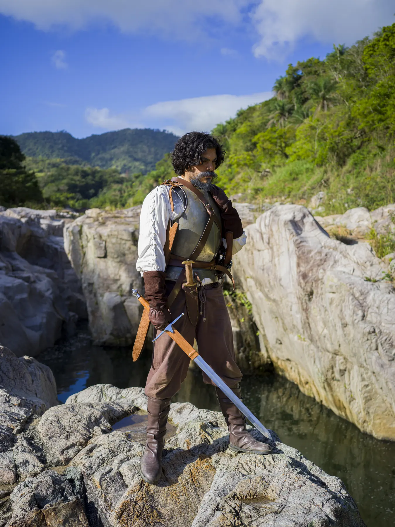 A man stands over the gorge, sword lowered